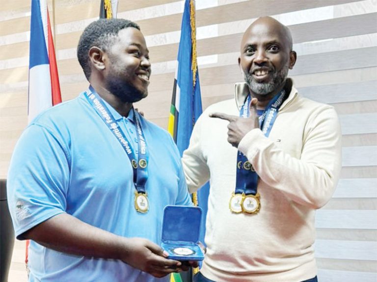 202509Dan-Tumukunde-shows-off-his-medals-to-Lawrence-Muganga