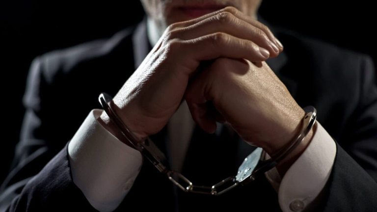Upset handcuffed man imprisoned for financial crime, punished for serious fraud