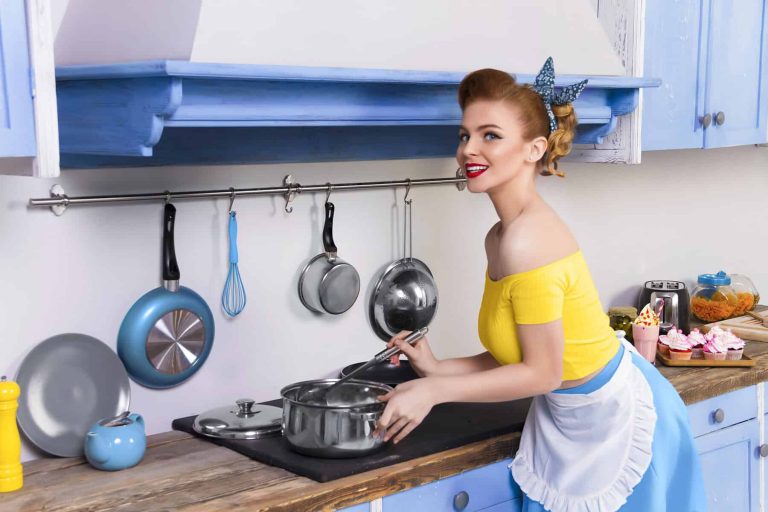 Retro pin up woman housewife in the kitchen