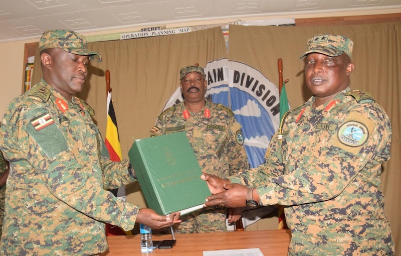 202510L-R-Brig-Gen-Paul-Muwonge-receiving-command-from-Maj-Gen-James-Birungi-early-July-as-Lt-Gen-Kayanja-Muhanga-looks-on
