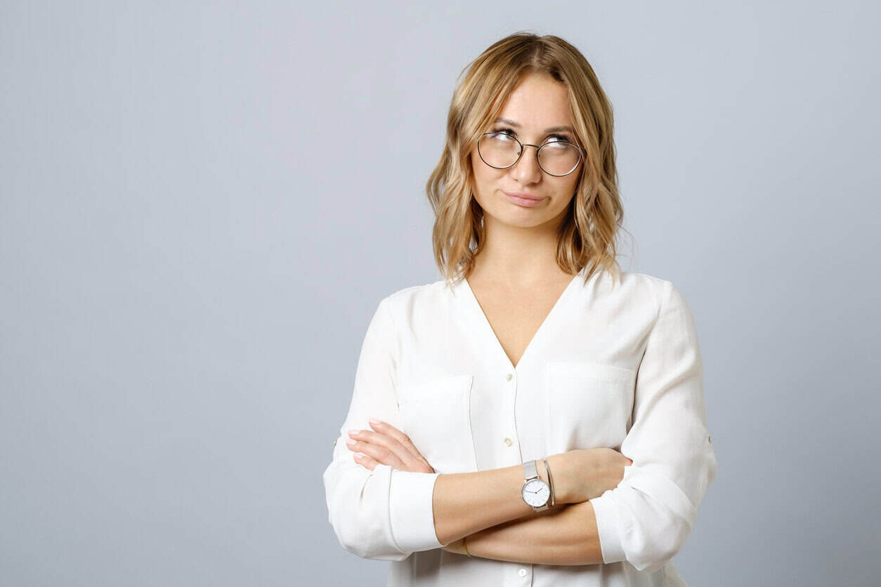 Image of thoughtful nervous young woman isolated over gray background