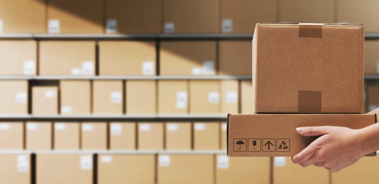 Warehouse worker holding delivery boxes