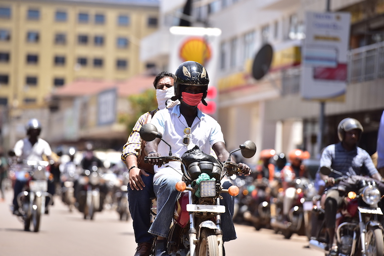202004Boda-boda-rider-carrying-passengers-in-Kampala