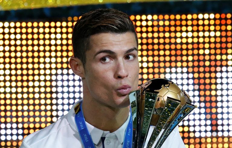 FILE PHOTO: Real Madrid's Cristiano Ronaldo celebrates winning the FIFA Club World Cup Final with the trophy