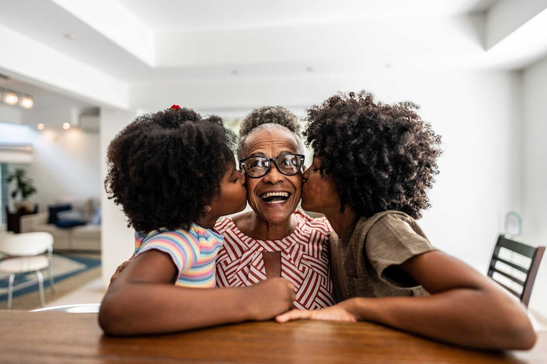 202511Portrait-of-grandmother-receiving-kiss-from-grandchildren-at-home-scaled-1