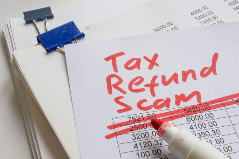 Stack of papers with the label tax refund scam.