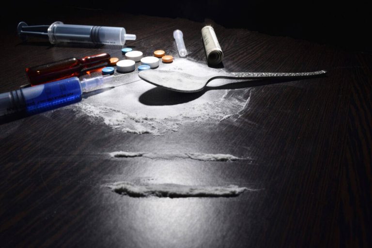 drugs concept , cocaine,injection,table,spoon on dark table