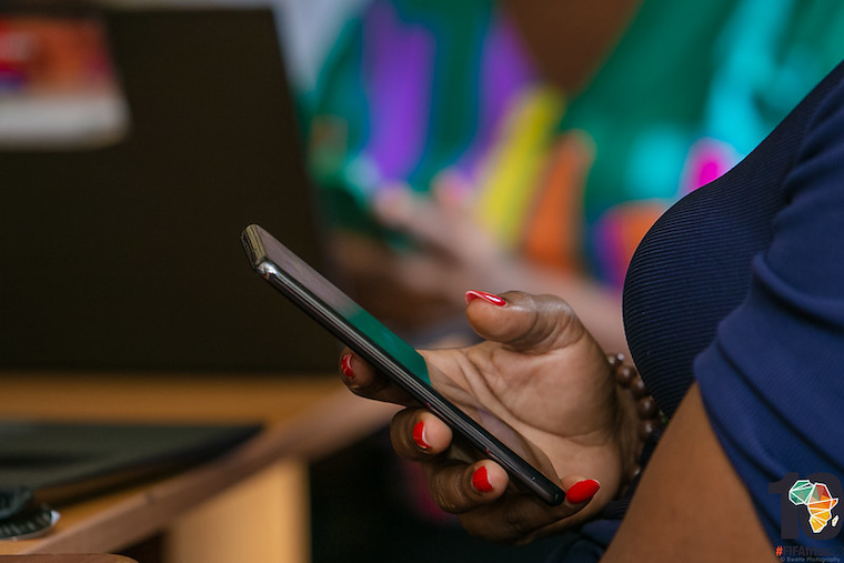 202310Woman-on-her-phone-at-the-FIFAfrica23