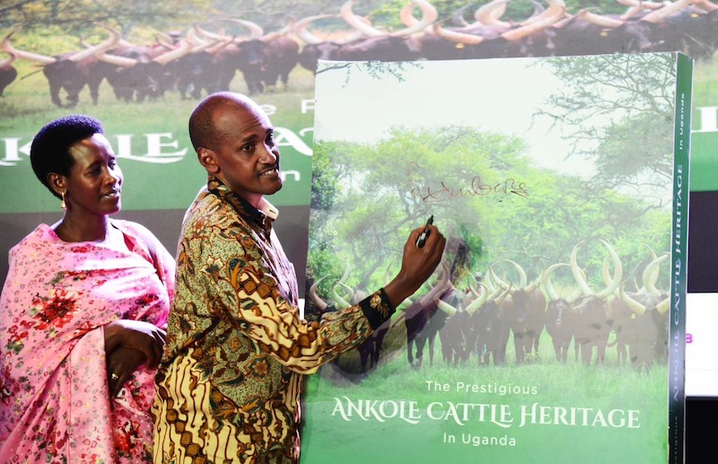 202512Agriculture-minister-Frank-Tumwebaze-signs-off-a-dummy-book-about-Ankole-cattle