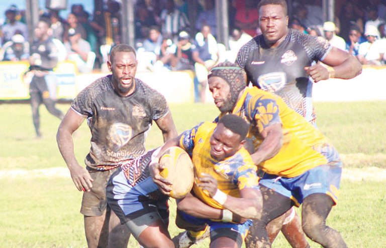 202512Heathens-Herbet-Champara-flanked-by-Lawrence-Ssebuliba-is-tackled-by-Pirates-William-Nkore