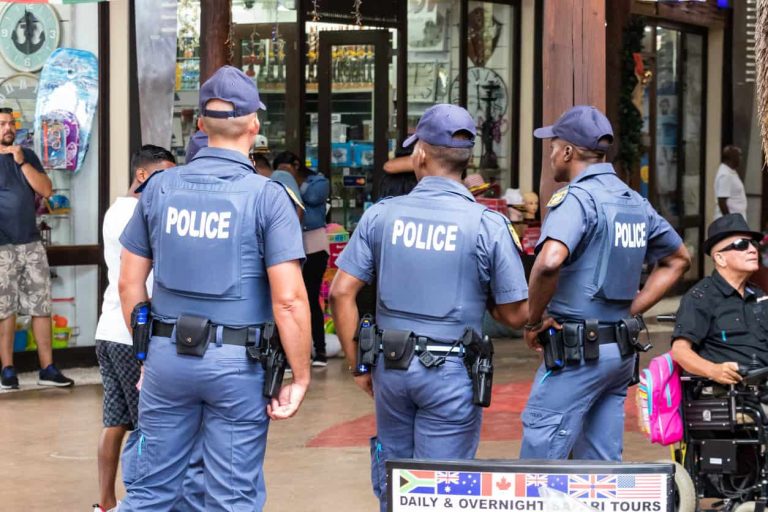 Rear view of three policemen watching over inside the UShaka Marine World in Durban, South Africa.
