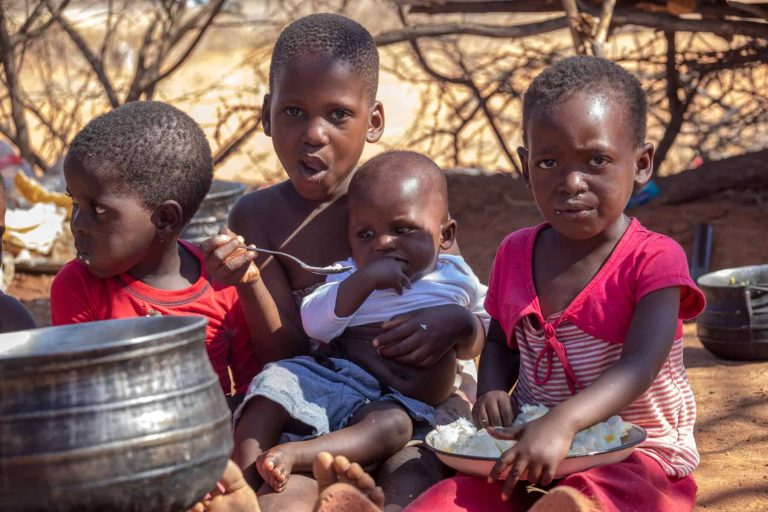 four african children in a village near Kalahari desert
