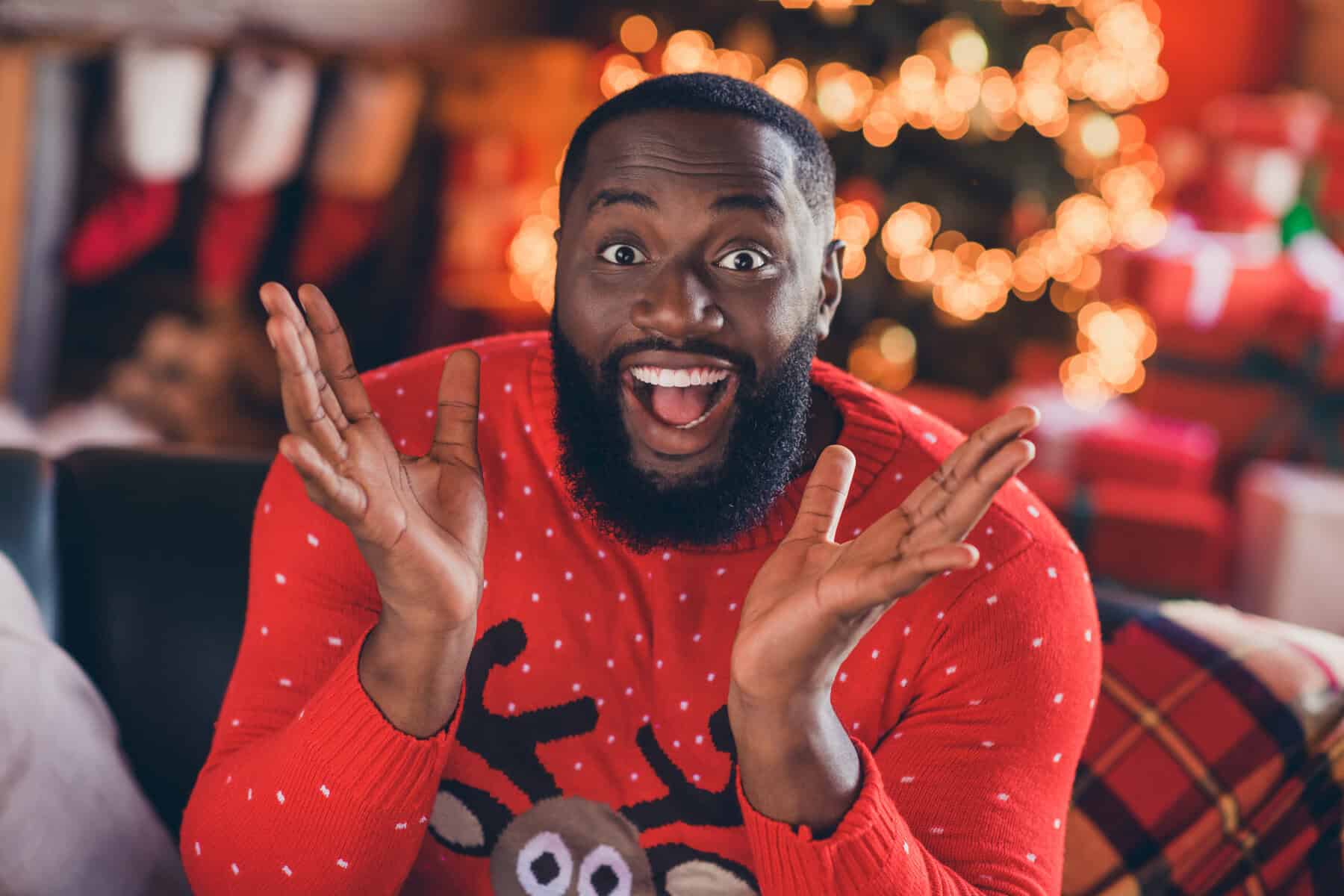 Photo of impressed young brunet guy wear red sweater at loft home new year
