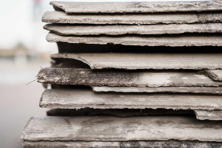 Old and very dangerous asbestos roof. Asbestos dust in the environment. Asbestos removal