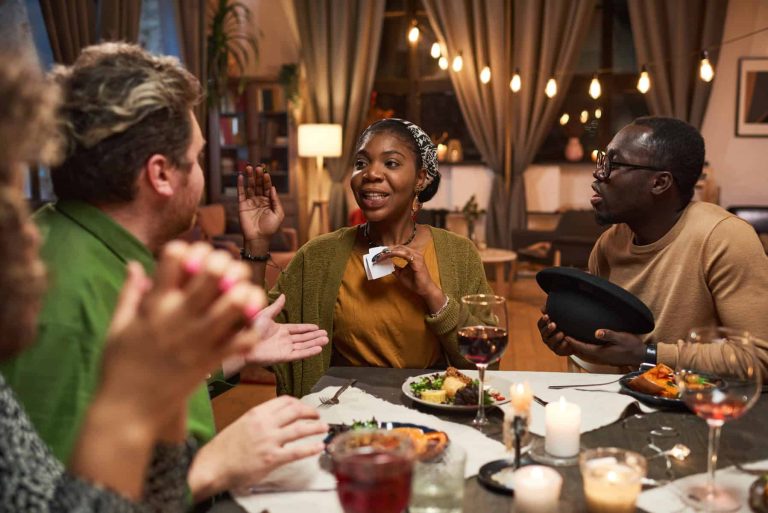Woman playing the game with friends at the table