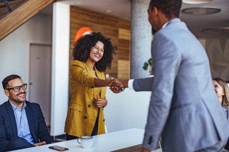Professional Team Engaged in a Business Meeting with Handshake Interaction