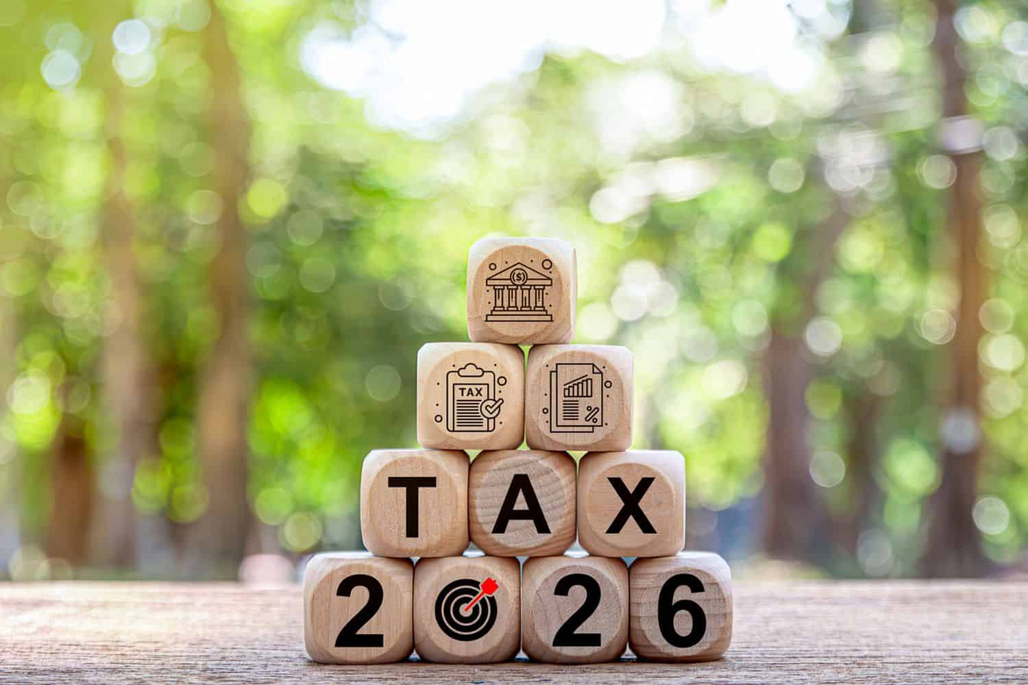 Tax and Vat 2026 Concept.Tax wooden letters on wooden cubes with 2026 on coins. income tax online return form for payment. Expenses, account, VAT, pay