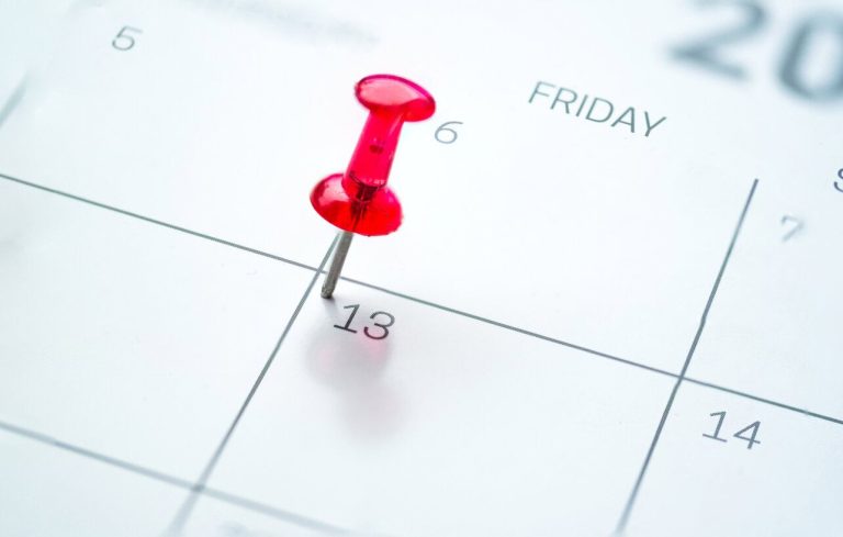 Red push pin on calendar