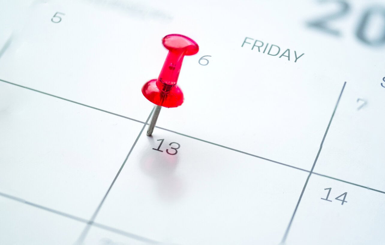 Red push pin on calendar