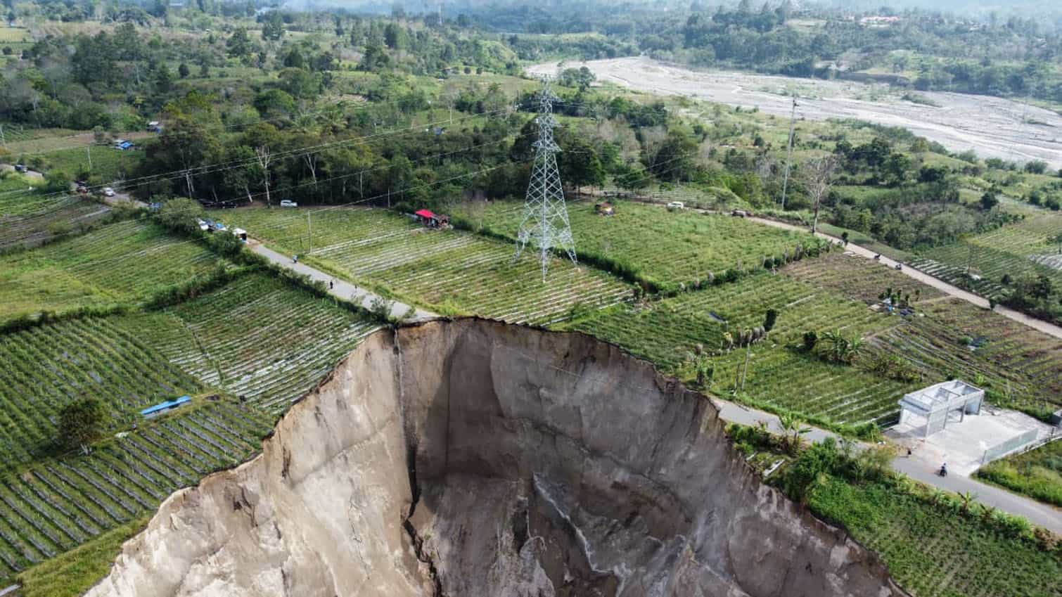 A sinkhole approximately 100 meters deep formed as a result of a ground collapse in Indonesia