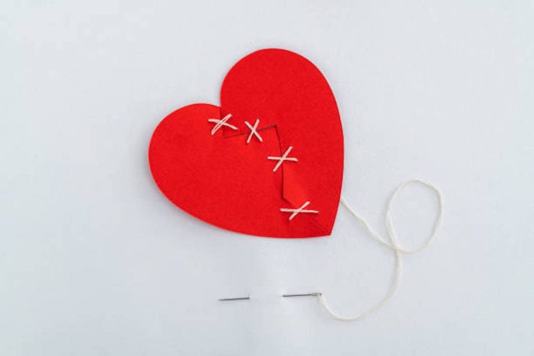 Suture the broken red heart with white thread