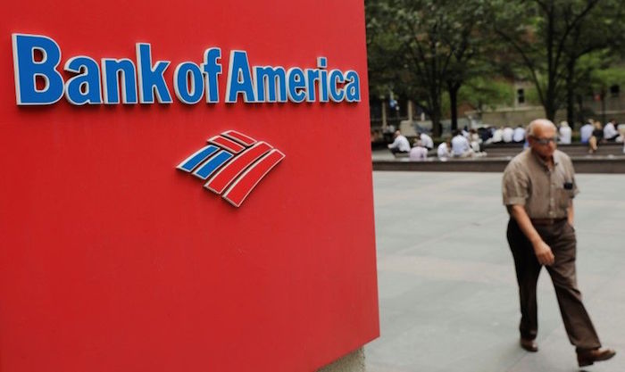A man walks past a Bank of America sign in New York
