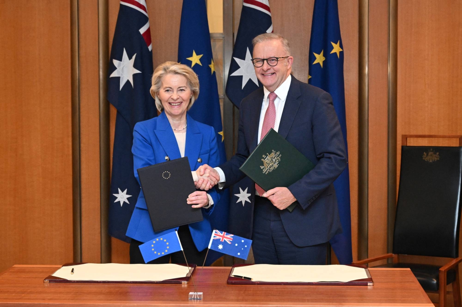 President of the European Commission Ursula von der Leyen and Australian Prime Minister Anthony Albanese pose with a signed joint statement during a ceremony at Parliament House in Canberra