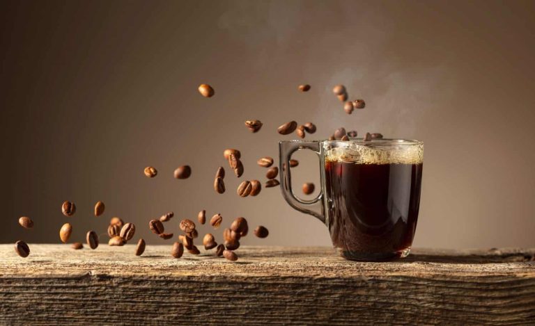 Espresso in glass cup on a old wooden table.
