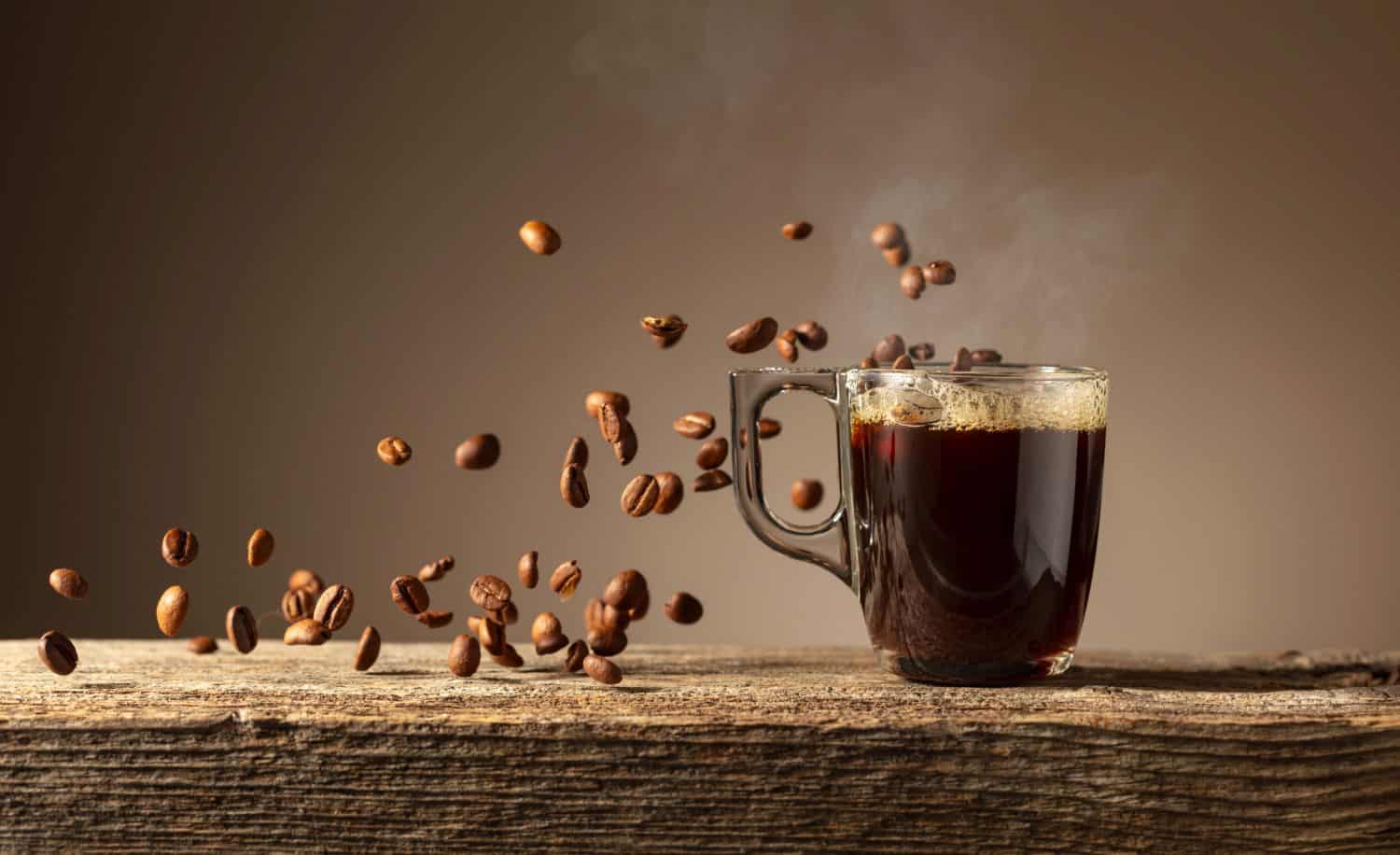 Espresso in glass cup on a old wooden table.