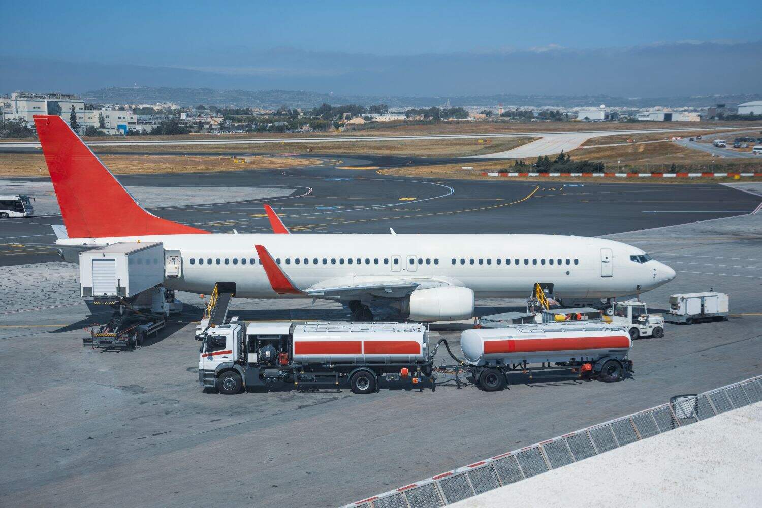 Truck with a tank and a trailer of aviation fuel during the refueling of the aircraft and its service before the flight.