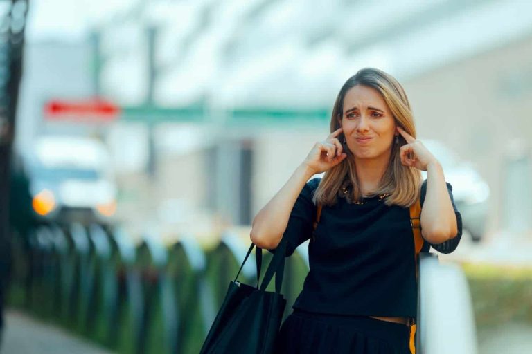 Unhappy Woman Covers Ears Dislikes Loud City Pollution