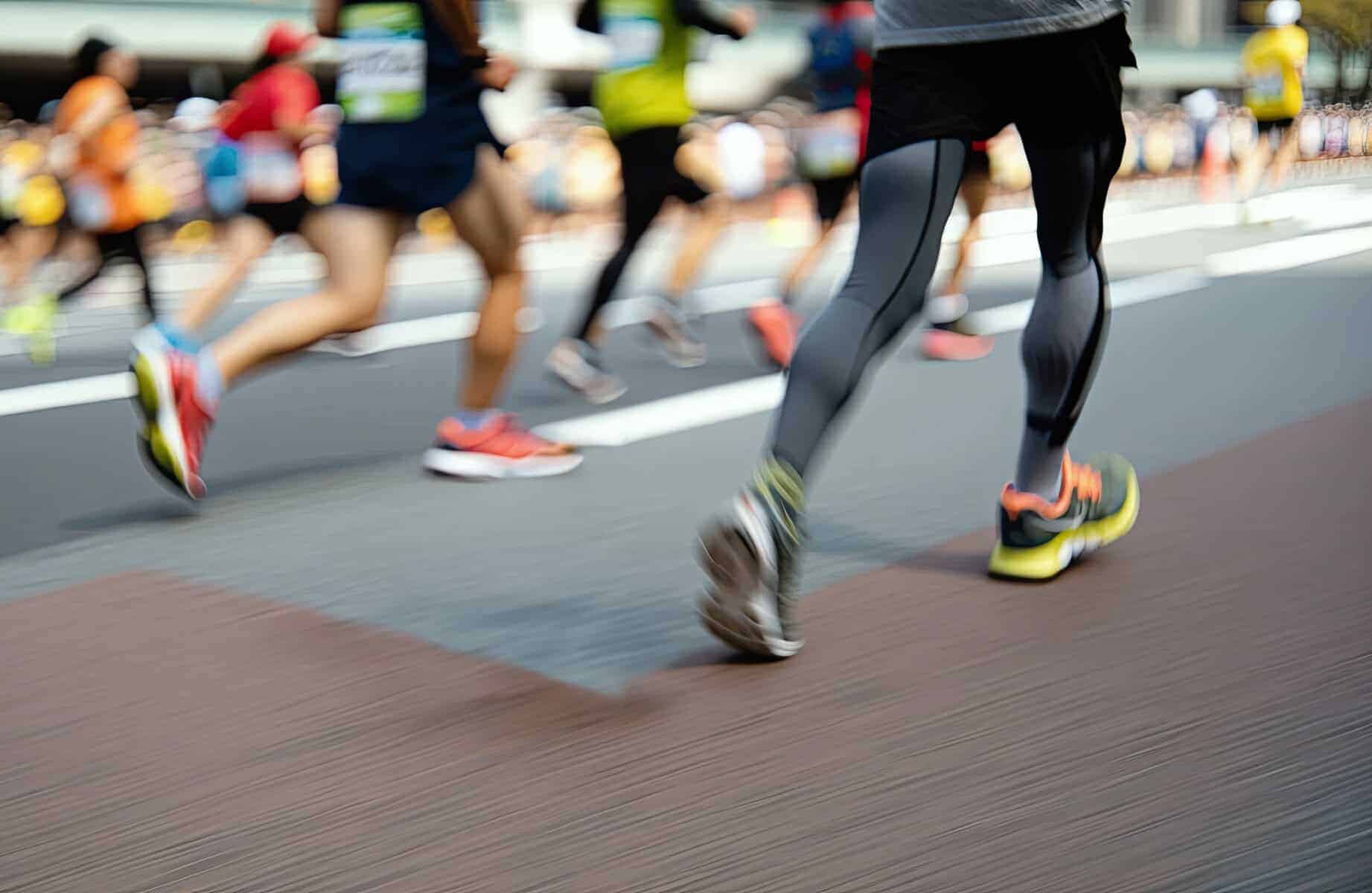 legs of runners in a city marathon race