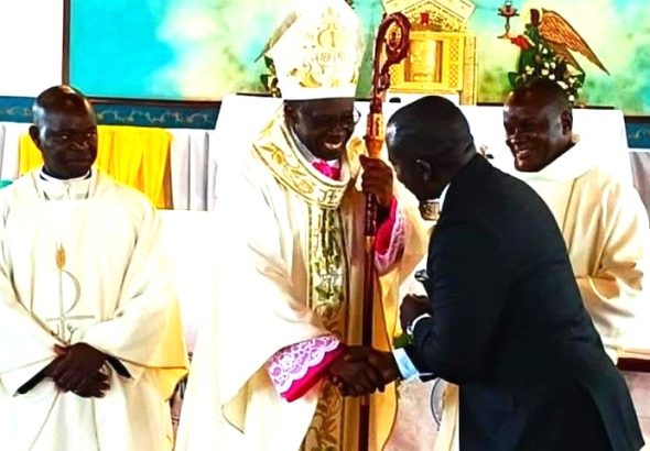 202604Bishop-Mukasa-shakes-hands-with-Denis-Ssekabira