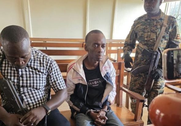 202604Christopher-Okello-Onyum-guarded-by-security