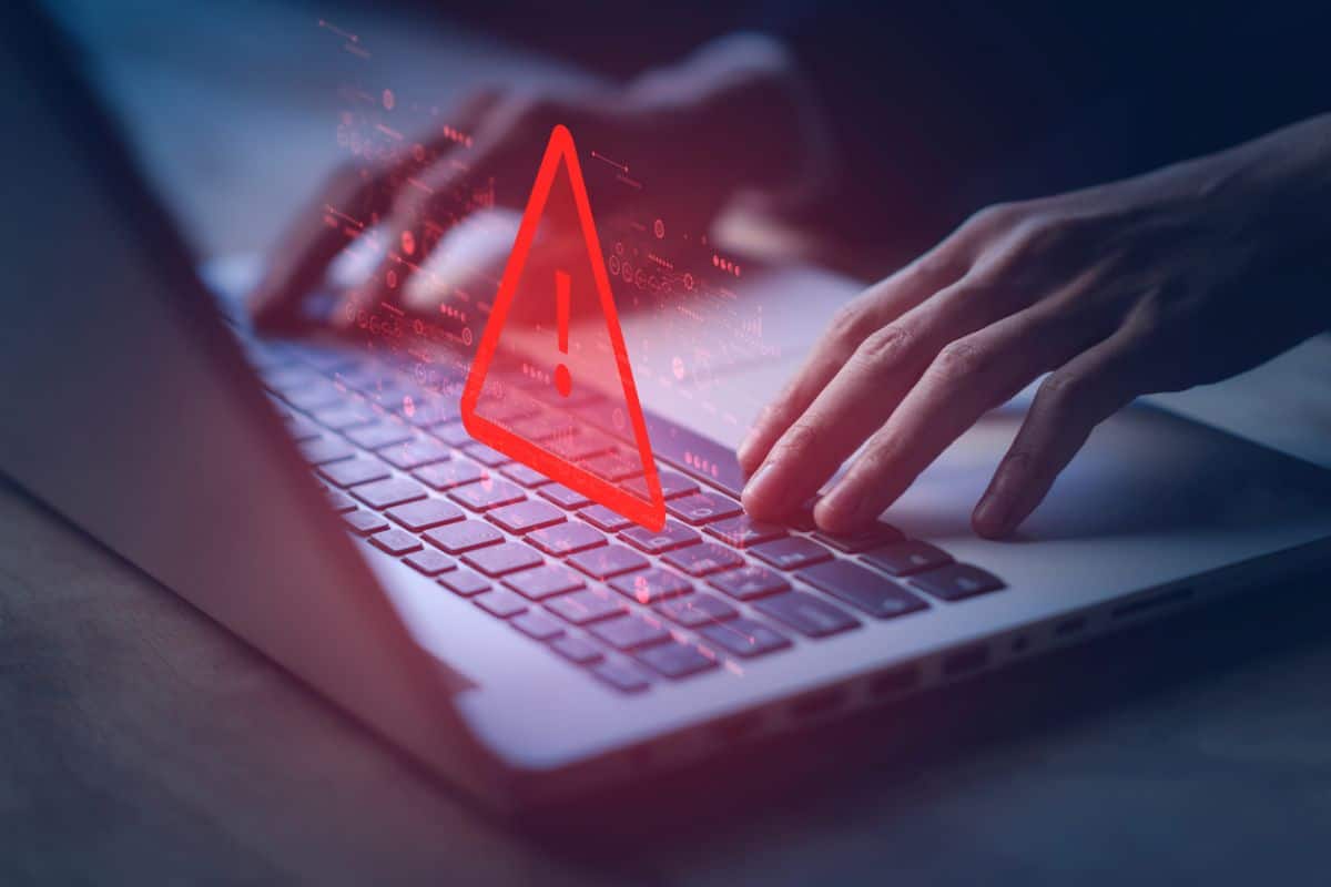 System hacked warning alert on notebook (Laptop). Cyber attack on computer network, Virus, Spyware, Malware or Malicious software. Cyber security and cybercrime. Compromised information internet.