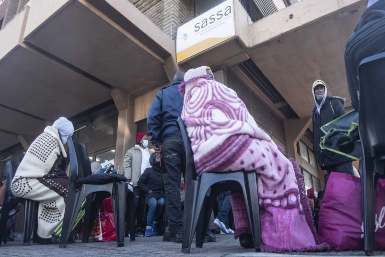 Grant beneficiaries queue outside Bellville SASSA Office