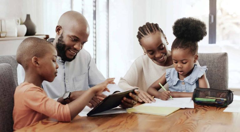 Black family, tablet or homework with a mother, father and children at the dining room table together for education. Technology, elearning or home school with a girl, boy and parents in their house