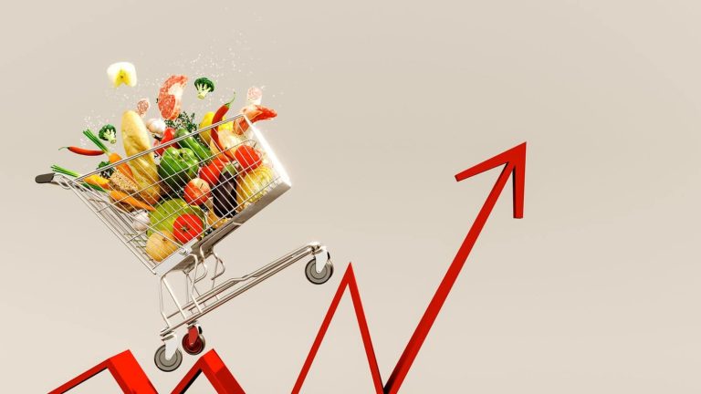 Food cost rising concept. Shopping cart full of groceries and red arrow pointing up