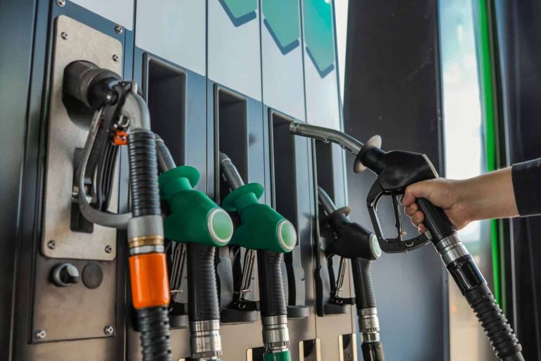 Fueling Up: A Hand Grips a Gas Pump Nozzle at a Station