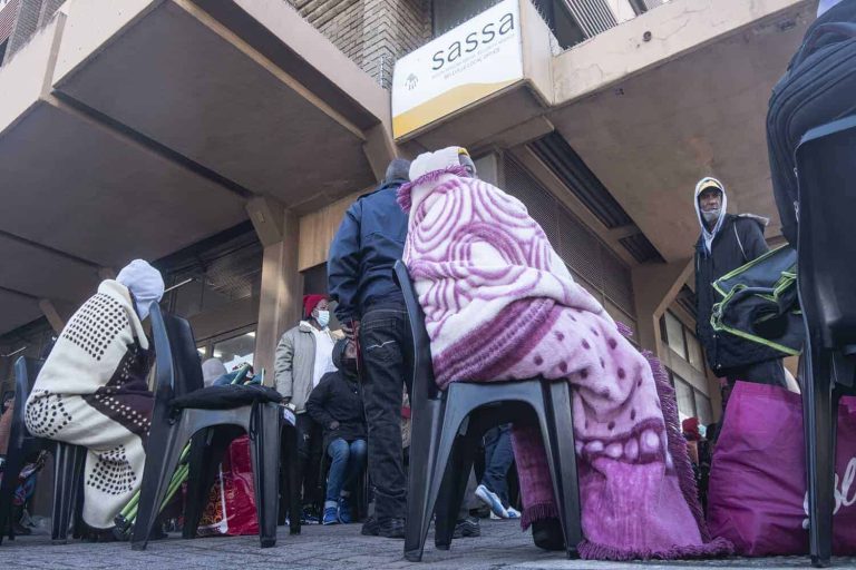 Grant beneficiaries queue outside Bellville SASSA Office