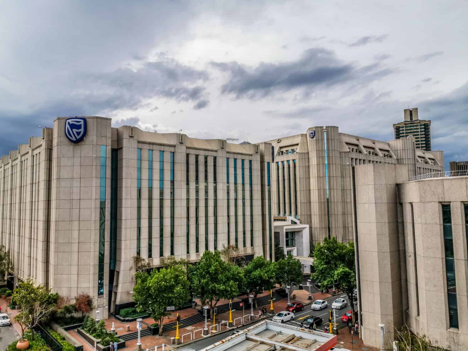 Beautiful and tall Standard bank buildings in Simmonds street Selby Johannesburg CBD area under a cloudy and sunset sky