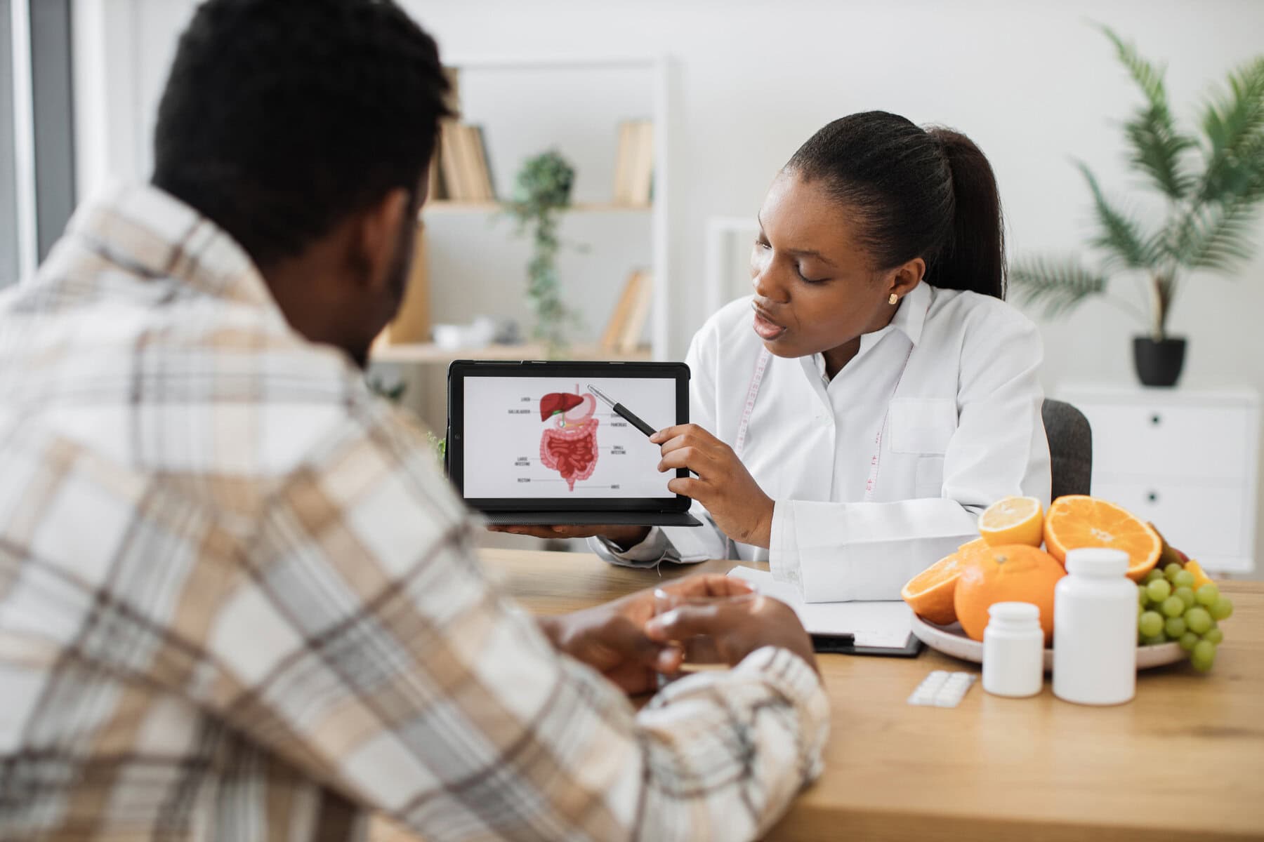 Woman holding tablet with GI tract while counseling client
