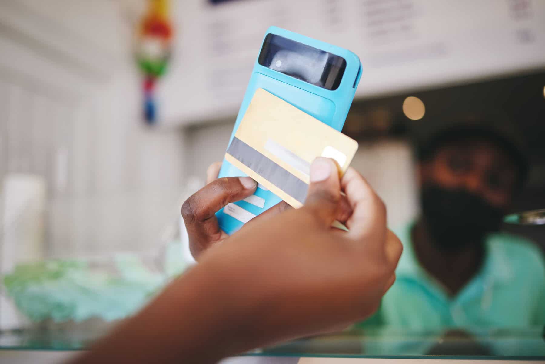 Customer hand payment using credit card, machine and 5g technology. Manager or cashier transacting with internet and nfc to tap or scan for the bill at grocery store contactless checkout point