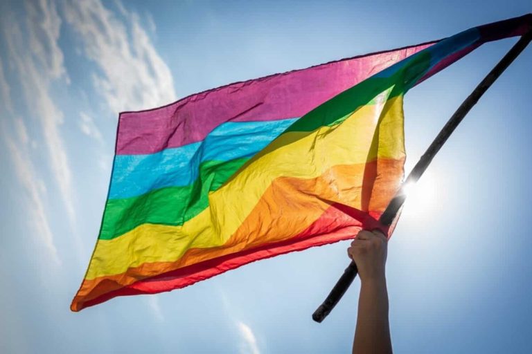 202604woman-waving-lgbti-flag-under-the-blue-sky-picture-id1313349355-1200x800-1