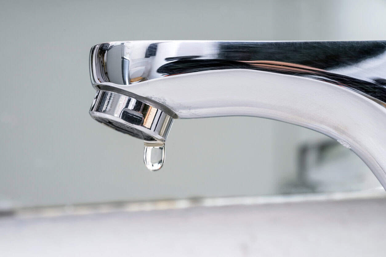 Drop of water falling from faucet.