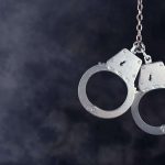 Handcuffs hanging on dark