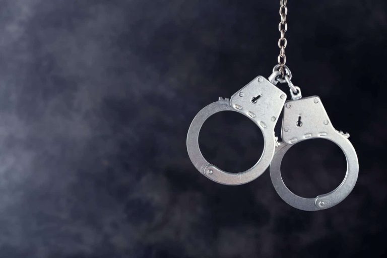 Handcuffs hanging on dark