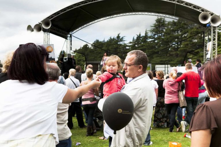 adult feeds child at the festival