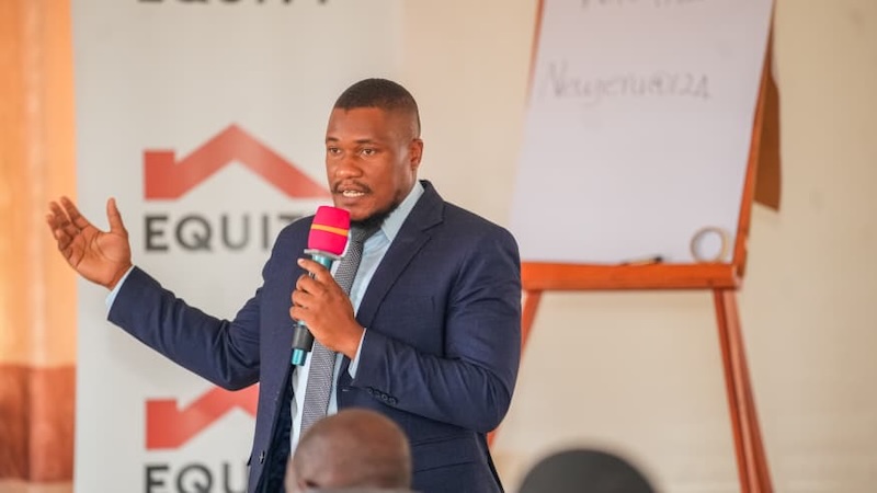202606Brian-Ddamba-SME-Business-Development-Manager-addressing-School-owners-during-a-School-Bridge-Financing-seminar