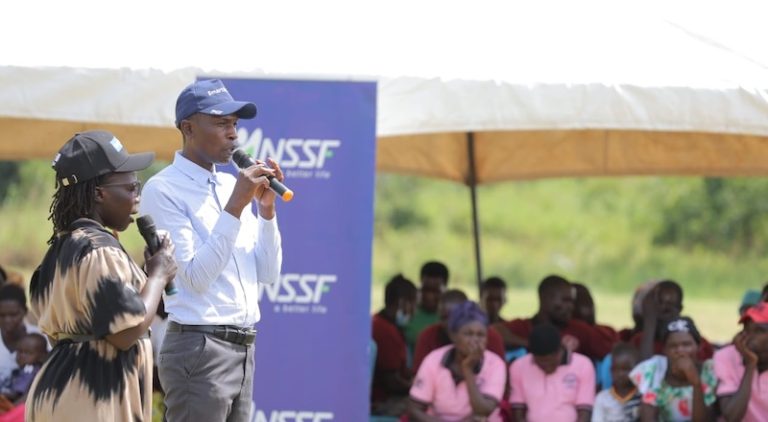 202606Dennis-Marsha-Kabuuka-Manager-Livelhoods-NSSF-and-Irene-Piloya-Program-office-Microfiance-Africa-Women-Rising-addressing-the-community-members-in-Omoro